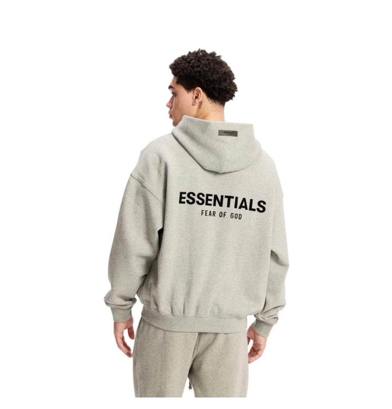 Person wearing grey hoodie in a white background 