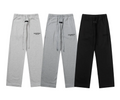 Three pairs of gray sweatpants and one black pants on a white background