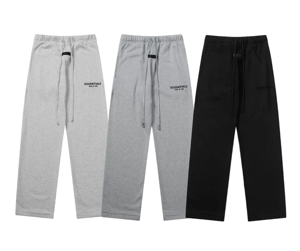 Three pairs of gray sweatpants and one black pants on a white background