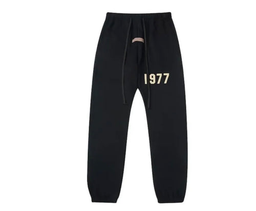 Black cuffed sweatpants with a white design 